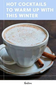 a cup of hot drink with cinnamon sticks in it and the words hot cocktails to warm up with this winter