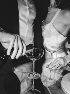 a man and woman sitting at a table with wine glasses