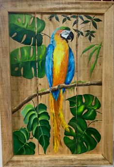 a painting of a blue and yellow parrot sitting on a branch in front of green leaves