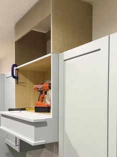 a white cabinet with some tools in it