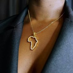 A statement necklace to elevate your style. Elegantly showcase the motherland with this sparkling Africa outline pendant guaranteed to attract attention. Dimensions Large Pendant: Width: 2.3cm/ Height: 3cm Small Pendant: Width: 1.1cm/ Height: 1.2cm Chain Length: 45cm + 5cm extension chain Material 18k Gold Plated  Brass Metal Base Gold, of at least 2.5 microns, is layered on top of a brass base to create a finish five times thicker than average gold plating, and far more durable. Expertly plated Africa Outline, Africa Pendant, Africa Necklace, Map Necklace, Africa Map, Pendant With Chain, Small Pendant, Brass Metal, Pendant Necklaces