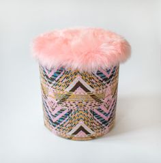 a pink furry hat sitting on top of a white table