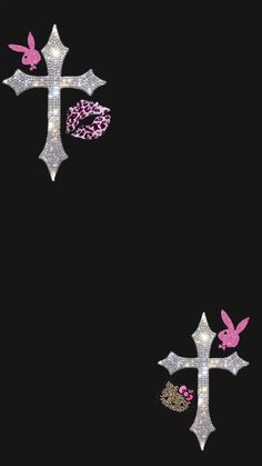 two crosses with pink and silver designs on black background, one is decorated with glitter