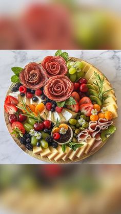 a platter filled with fruit and flowers on top of a marble counter