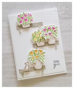 a card with flowers in pots on it