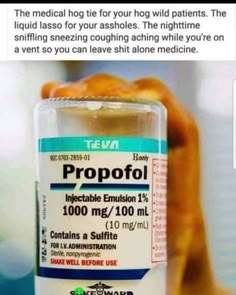 a bottle of propofol sitting on top of a table next to a hand