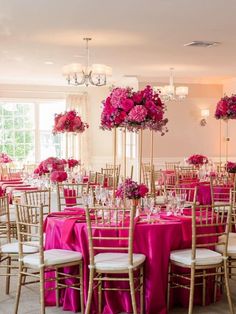 a room filled with lots of tables covered in pink flowers