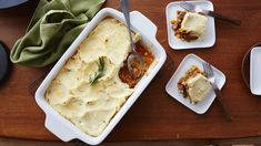 a table topped with two white dishes filled with lasagna casserole covered in cheese