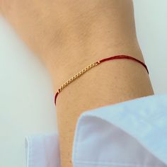 Close-up of hand wearing delicate red thread bracelet with gold chain detail at center. Adjustable Gold Bracelet For Friendship, Red Bangle Bracelet For Everyday, Everyday Red Bangle Bracelets, Red Everyday Bangle Bracelets, Thread Bracelet, Red Bracelet, Thread Chains, Diy Bracelets With String, Diy Beaded Bracelets