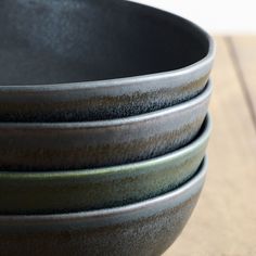 three black bowls stacked on top of each other