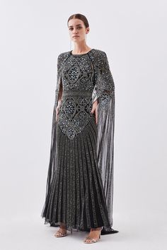 {@@=Ist.Core.Helpers.StringHelper.ToProperCase("Adorned with an abundance of glistening sequins and beads, this floor-sweeping gown is a vision of ethereal opulence. A cascading cape adds a sense of drama, while mesh details bring an alluring element.EmbellishedCape dressMaxi LengthHigh neckExpertly designed for those 5'3" and under, our Petite pieces are perfectly proportioned for a smaller frame using shorter lengths.")} Creative Black Tie, Latest Maxi Dresses, Black Beaded Dress, Karen Millen Dress, Petite Maxi Dress, Maxi Dress Collection, Dress Silver, Wedding Guest Looks, Cape Dress