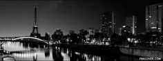 the eiffel tower is lit up in black and white as seen from across the river