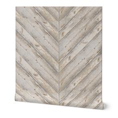 a white and grey chevroned wallpaper with wood planks on the side