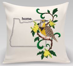 a pillow with a bird sitting on top of it's back and the words home