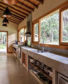 a kitchen with lots of counter space and large windows