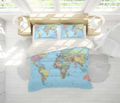 a bed with a blue world map comforter and pillows