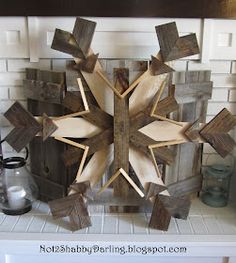 a wooden snowflake sitting on top of a mantle