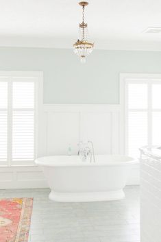 a white bath tub sitting inside of a bathroom