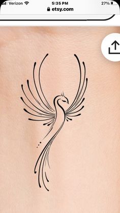 the back of a woman's stomach with a bird tattoo on her left side