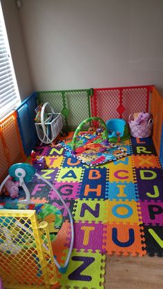 a child's play room with colorful rugs and toys on the floor in it