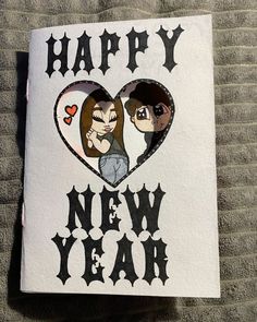 a happy new year card with two people in the shape of a heart on it