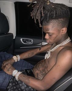 a man with dreadlocks sitting in a car