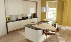 a modern kitchen with an island table and stools