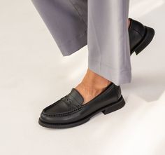 Introducing our Women's Black Leather Loafers, a fashion staple for every style-conscious individual! These timeless loafers feature a sleek and versatile black leather exterior that effortlessly elevates any outfit. With their sophisticated design and comfortable fit, these black penny loafers are the perfect addition to your wardrobe. Whether you're dressing up for a special occasion or simply want to add a touch of elegance to your everyday look, these loafers are a must-have! Crafted with the finest materials, our black leather loafers are durable and exude a sense of luxury. Step up your fashion game with these classic black penny loafers and make a statement wherever you go. Casual Slip-on Loafers For Work, Timeless Almond Toe Slip-ons For Work, Black Slip-ons With Rubber Sole For Work, Timeless Workwear Slip-ons With Plain Toe, Black Dress Shoes With Stitched Sole For Work, Timeless Round Toe Slip-ons For Work, Slip-on Oxfords For Workwear In Fall, Slip-on Platform Loafers With Rubber Sole For Work, Slip-on Loafers For Workwear In Fall