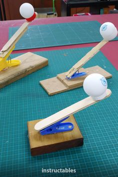 two wooden paddles and some balls on a table