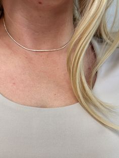 Adorn your neck with this stunning 18k Gold-filled Tennis necklace. Delicate and minimalist, its classic look is sure to make a statement. Our 1.2mm Cubic Zirconia stones shine brightly, making this the perfect accessory for any outfit. Metal: 18k Gold Filled High-quality AAAAA Cubic Zirconia Material: 1.2mm micro CZ chain Size: 12 inches long + 4 inches extender chain Hypoallergenic Water-resistant Handcrafted in Brazil Also available our matching Tennis Bracelet to complete your outfit. Silver Minimalist Tennis Necklace For Everyday Wear, Minimalist Diamond Tennis Necklace As Gift, Minimalist Silver Tennis Necklace For Everyday, Everyday Silver Minimalist Tennis Necklace, Everyday Minimalist Silver Tennis Necklace, Fine Jewelry Tennis Necklace For Everyday, Silver Minimalist Diamond Tennis Necklace, Minimalist Silver Diamond Tennis Necklace, Everyday Fine Jewelry Tennis Necklace