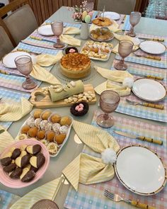 a table is set with desserts and dishes for an easter brunch party