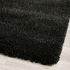 a black shaggy rug on the floor