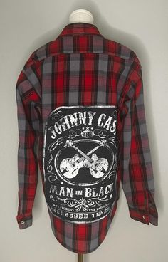 Celebrate the legacy of the legendary Johnny Cash with this vintage Codet flannel shirt. Featuring a classic red and grey plaid pattern, this durable flannel is not just for keeping warm but also for showcasing your love for the 'Man in Black.' The back graphic is a tribute to Johnny Cash and his Tennessee Three, adding a touch of rock 'n' roll to this timeless outdoor staple. Perfect for fans of vintage music memorabilia and quality outdoor wear. Size [insert size]. Excellent vintage condition Plaid Cotton Flannel Shirt With Graphic Print, Vintage Plaid Flannel Shirt With Graphic Print, Plaid Flannel Shirt With Graphic Print, Plaid Graphic Print Flannel Shirt, Man In Black, Men In Black, Rock N’roll, Grey Plaid, Johnny Cash