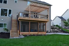 a house with a deck and patio in the back yard