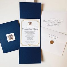 the wedding stationery is laid out on top of each other, including two envelopes