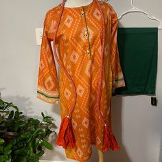 Pakistani/ Indian Edenrobe Qameez , Lime Light Trouser And Dupatta Set . Orange Long Sleeve Traditional Wear For Navratri, Orange Anarkali Set With Printed Motifs, Festive Orange Traditional Wear With Printed Motifs, Anarkali Orange Kurta With Printed Motifs, Orange Anarkali Dress With Printed Motifs, Orange Bohemian Sets For Festivals, Orange Anarkali Salwar Kameez With Printed Motifs, Orange Anarkali Kurta With Printed Motifs, Festive Orange Salwar Kameez With Printed Motifs