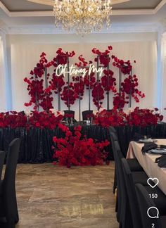 a room filled with tables and chairs covered in red flowers