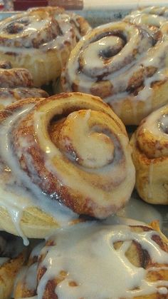 cinnamon rolls with icing sitting on a plate