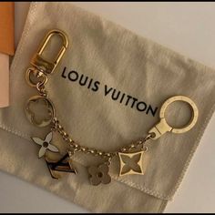 a louis vuitton keychain with charms on it