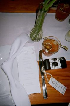 the table is set with silverware, utensils and menus