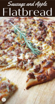 sausage and apple flatbread pizza on a wooden cutting board with rosemary sprigs