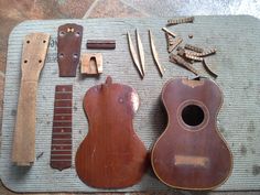 an assortment of musical instruments and tools laid out on a mat with wood shavings