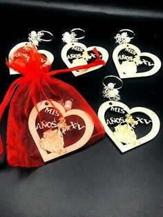 six heart shaped ornaments with red organ bag on black table top next to each other