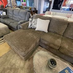 a living room filled with lots of couches and pillows on top of each other