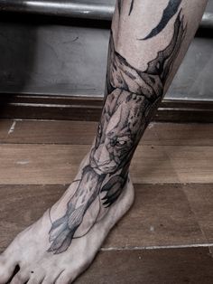 a man's leg with a tattoo on it that has an image of a bird flying through the air