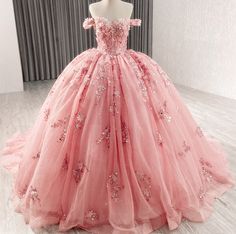 a pink ball gown with flowers on it