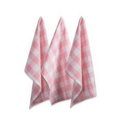 three pink and white checkered towels on top of each other