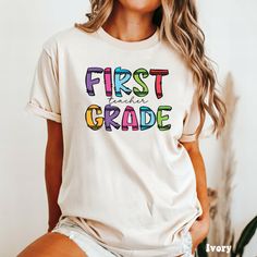 ✏️ This first grade teacher shirt is made to order just for you. This would be a great gift for a true 1st grade teacher at heart.   👉🏼 HOW TO ORDER  1. Please check and review all photos  2. Select your shirt size and color from thedropdown menu  3. Choose your quantity  4. Click add to cart. You can go back and add more items.  5. Click proceed to checkout  6. Wait for your package to arrive and enjoy your item!  🌸 WHAT YOU WILL GET  A classic unisex comfort colors short sleeve tee that fit Personalized Teacher Appreciation T-shirt For Back To School, Personalized T-shirt For Teacher Appreciation And Back To School, Personalized Cotton Tops For Back To School, Personalized Tops For Back To School, First Grade Shirt, 1st Grade Teacher, First Grade Teacher, First Grade Teachers, Color Shorts