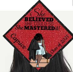 a red and black graduation cap with the words she belived she could so she mastered