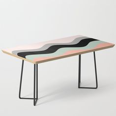 a wooden table with black metal legs and a multicolored design